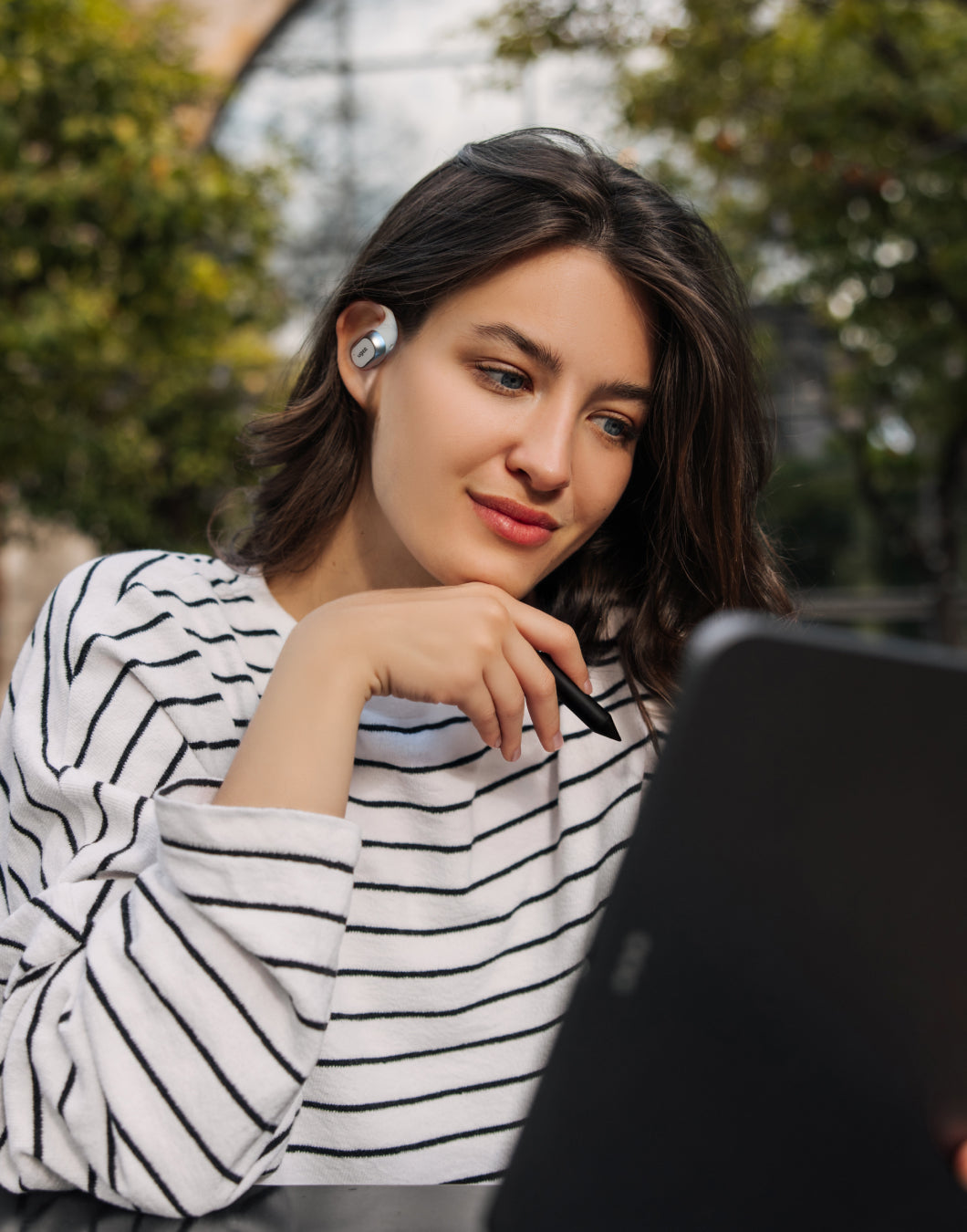 a women draw with wrap around earbuds